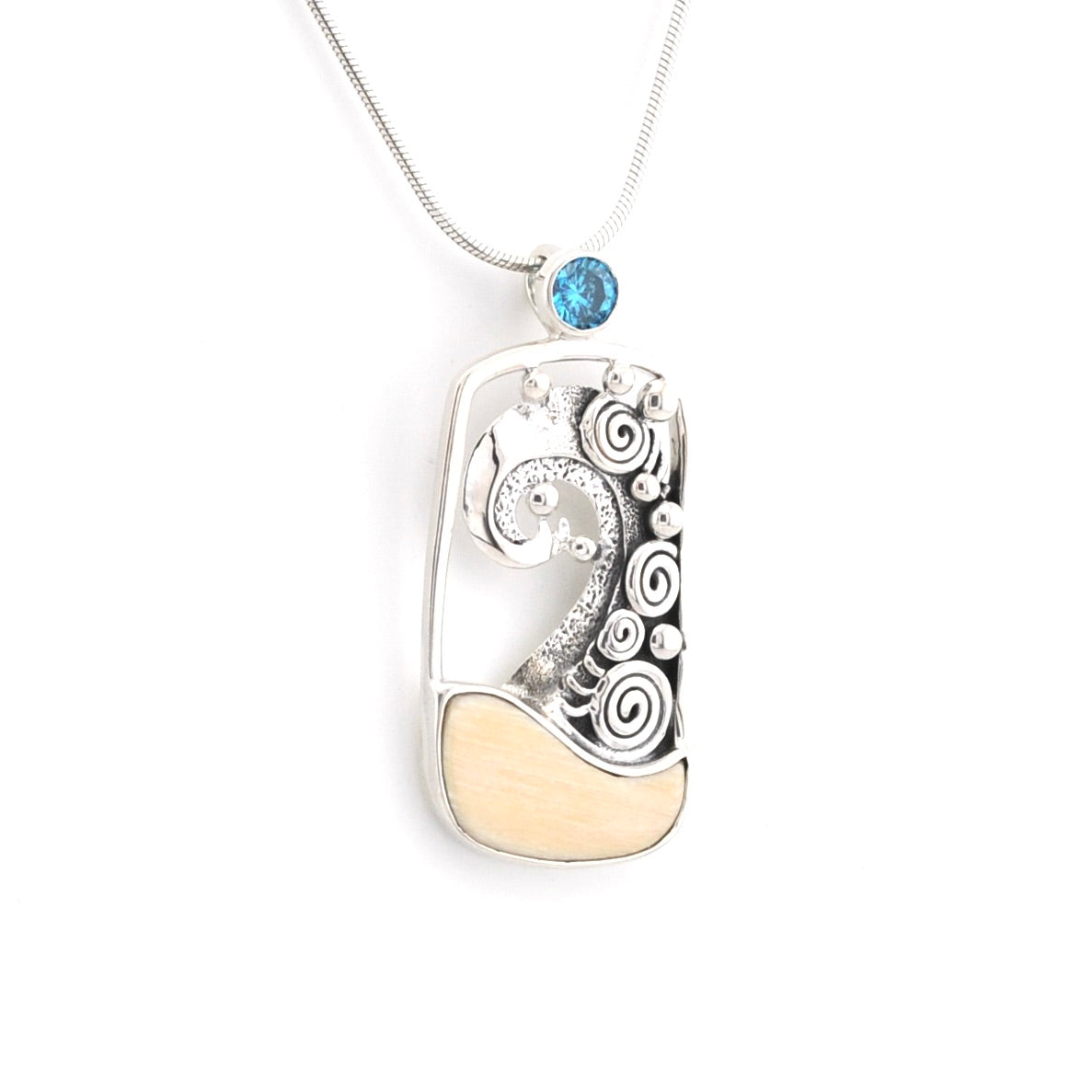 Silver wave pendant with a blue gemstone on a white background