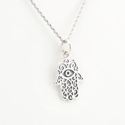 Silver Hamsa hand necklace on a white background