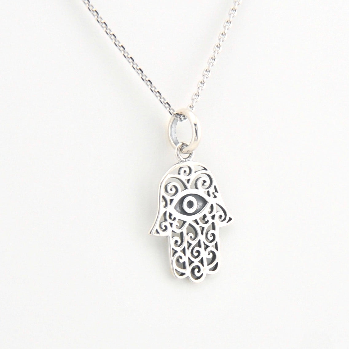 Silver Hamsa hand necklace on a white background