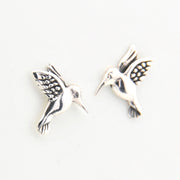 Silver bird-shaped earrings on a white background