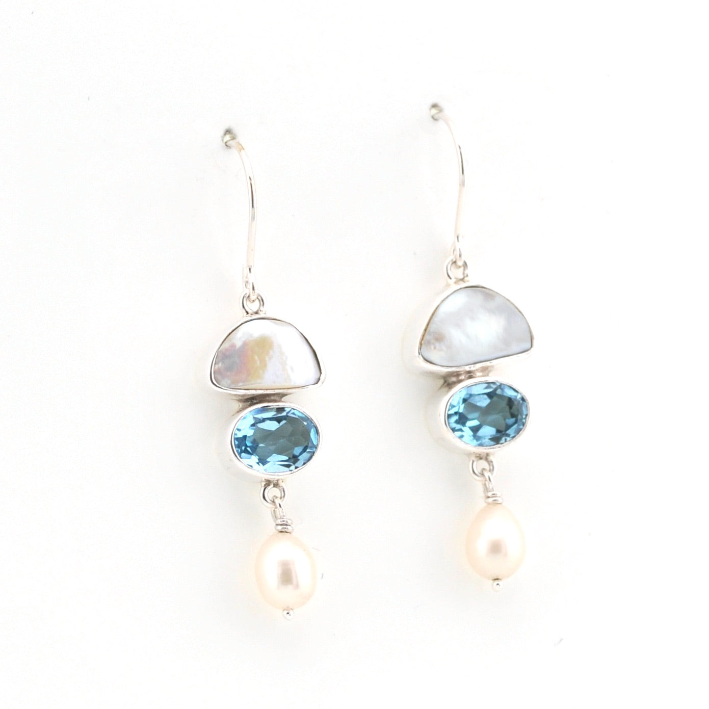 Pair of earrings with gemstones and pearls on a white background