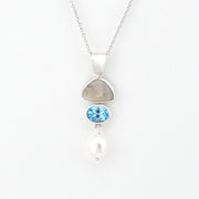 Necklace with pendant featuring a blue gemstone and pearl on a white background