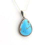 Turquoise pendant necklace on a white background