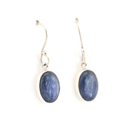 Pair of silver earrings with blue oval stones on a white background