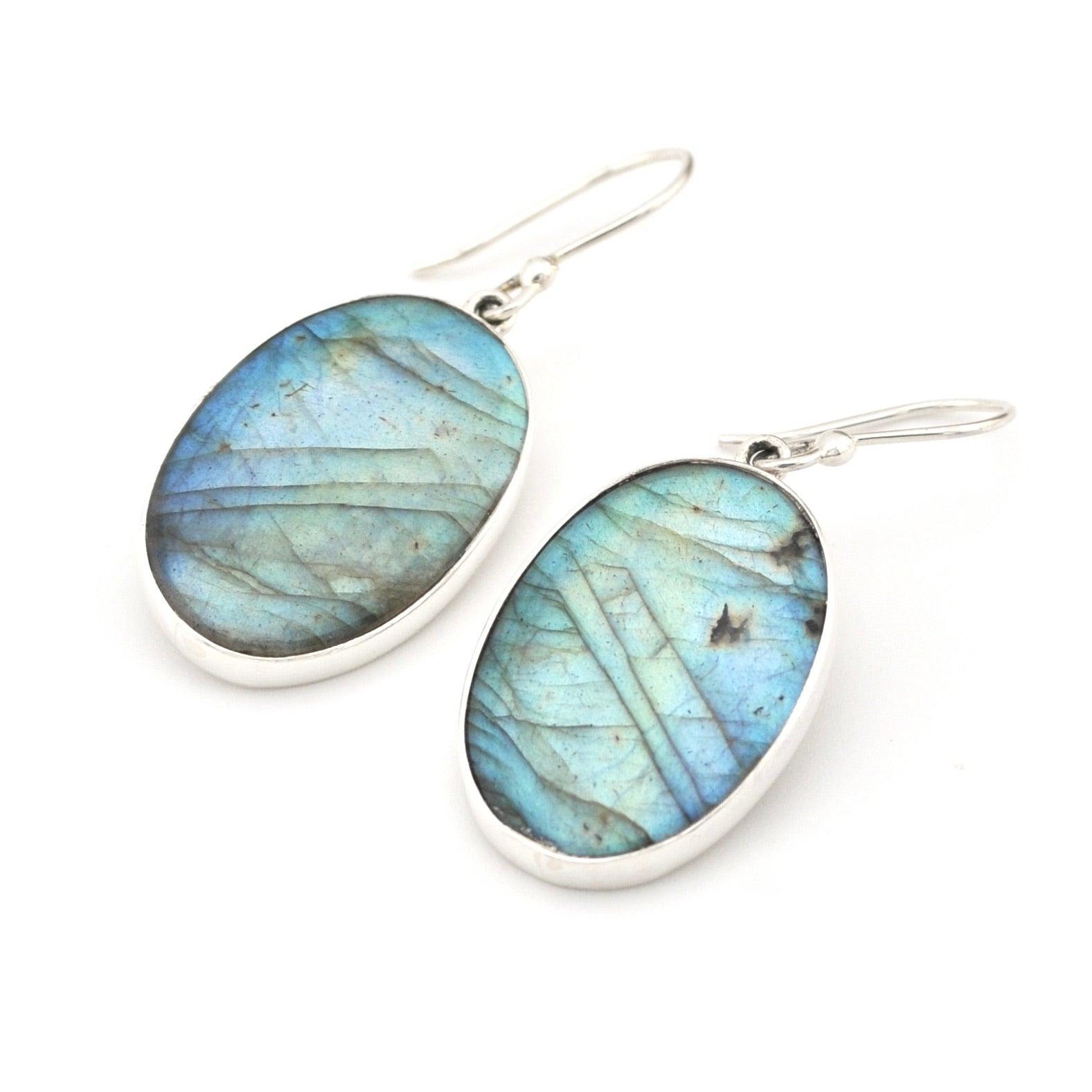 Blue gemstone earrings with silver hooks on a white background