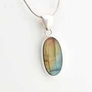 Silver pendant with a colorful stone on a white background