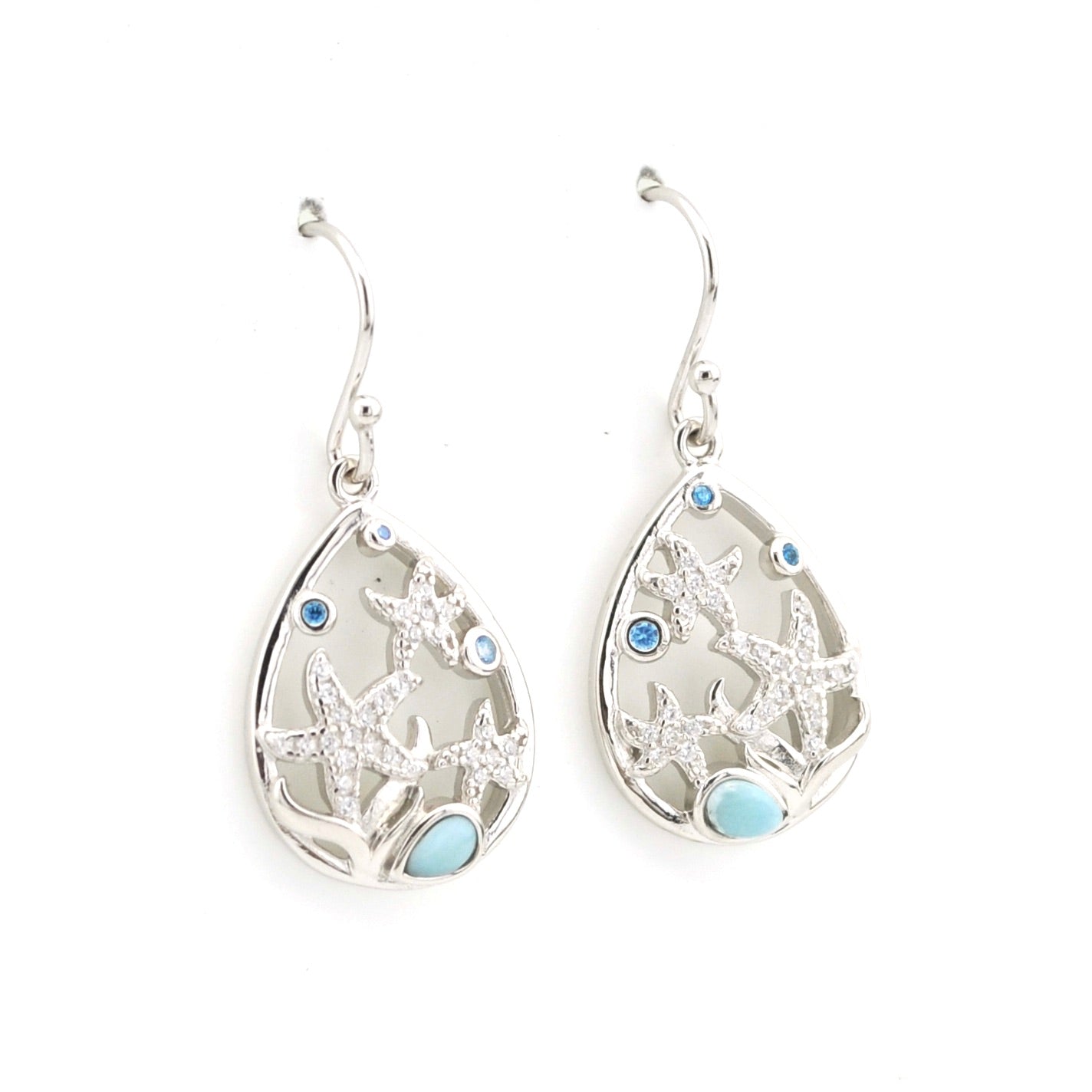 Silver earrings with starfish and blue gemstone design on a white background