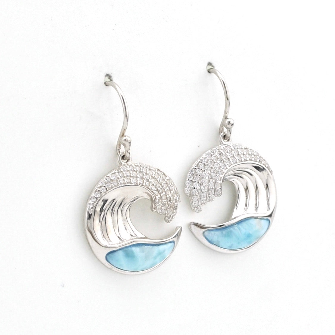 Silver wave-shaped earrings with blue accents on a white background