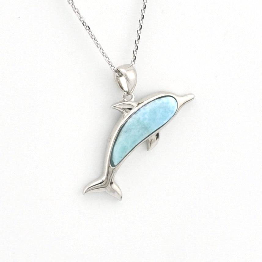 Dolphin pendant with larimar on a silver chain on white background.