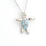 Silver turtle pendant with a light blue shell on a white background