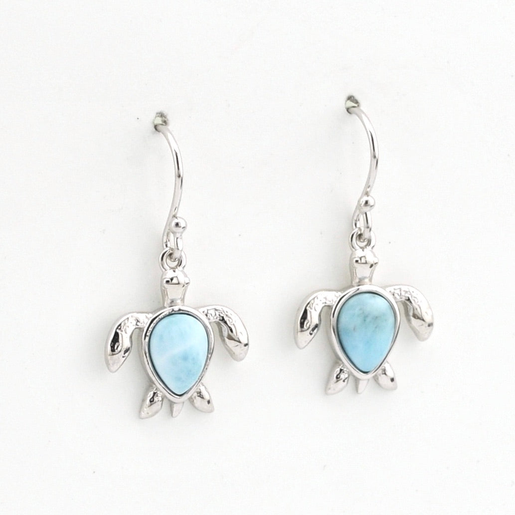 Turtle-shaped earrings with blue gemstones on a white background
