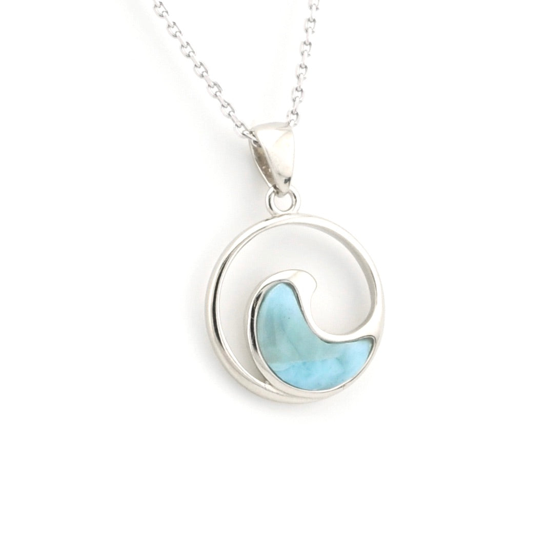 Silver necklace with a circular pendant featuring a blue stone on a white background