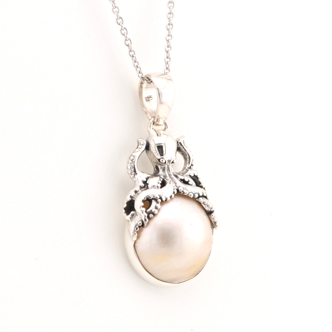 Pearl pendant necklace on a white background