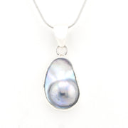 Pearl pendant on a chain against a white background