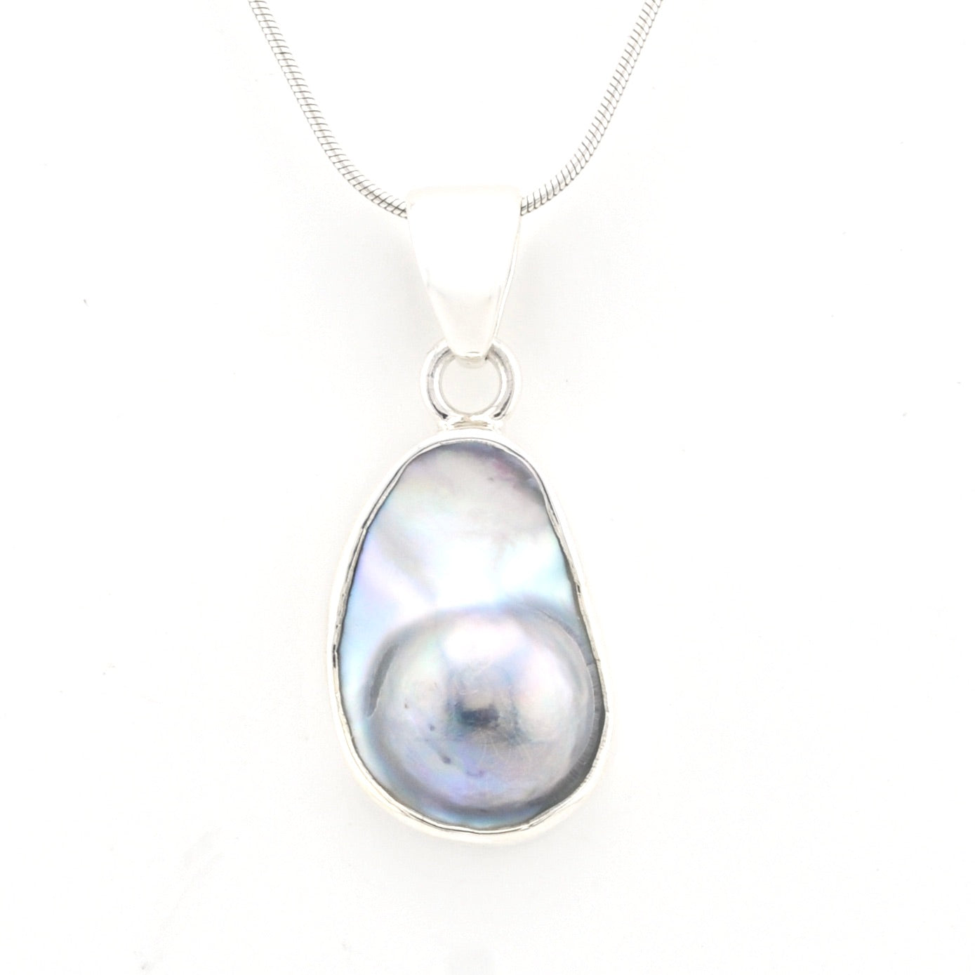 Pearl pendant on a chain against a white background