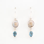 Pair of earrings with shell and blue gemstone drops on a white background