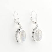 Pair of silver earrings with moonstone stones on a white background