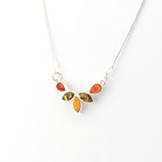 Necklace with amber-colored stones on a white background