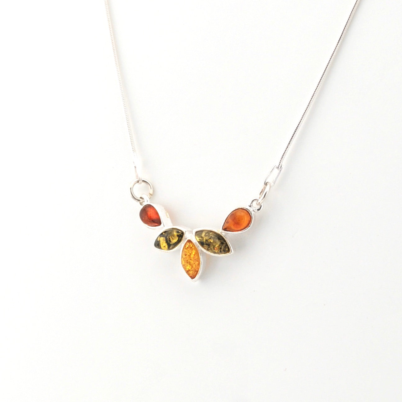 Necklace with amber-colored stones on a white background