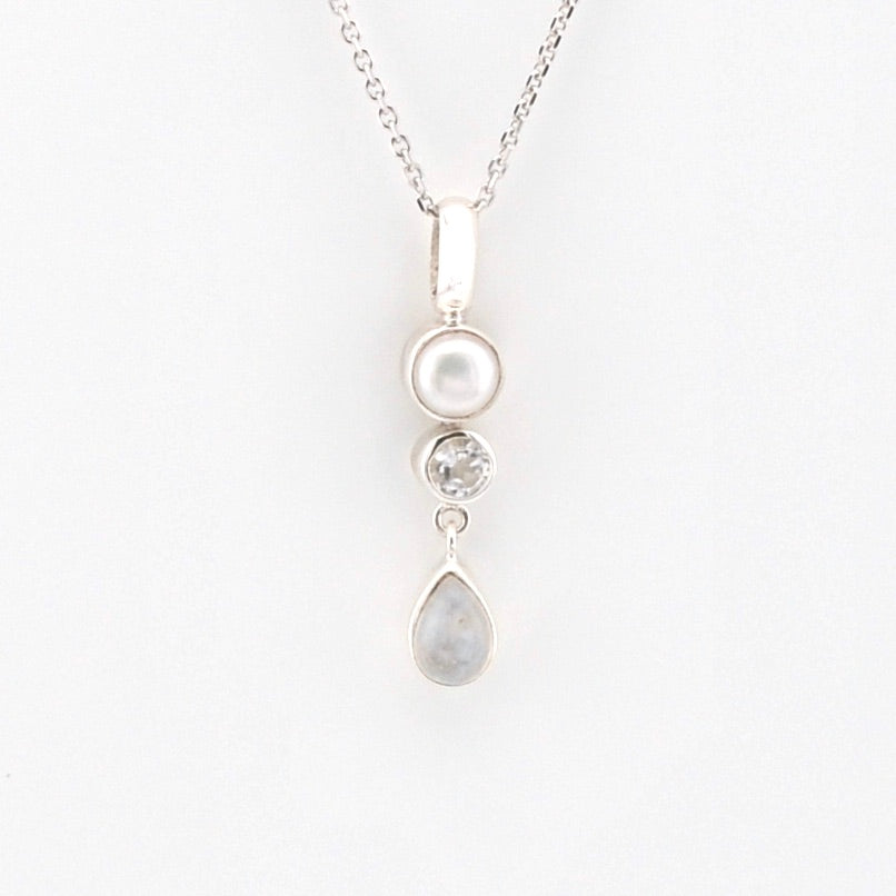 Silver necklace with three pendant drops on a white background