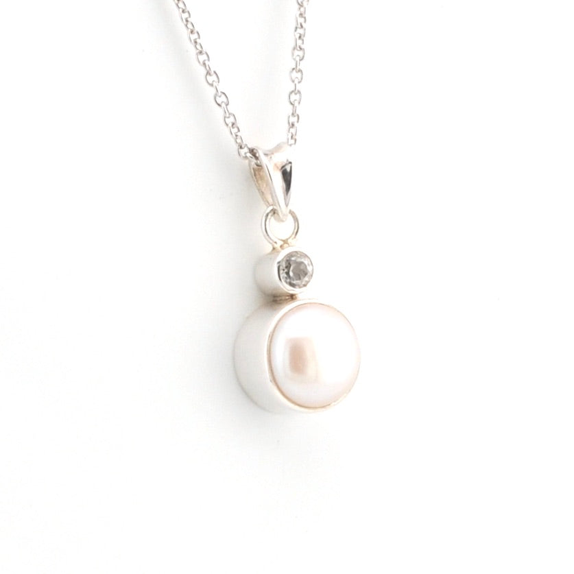 Pearl necklace with a silver chain on a white background