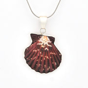 Shell-shaped pendant on a chain against a white background
