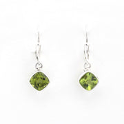 Green gemstone earrings on white background