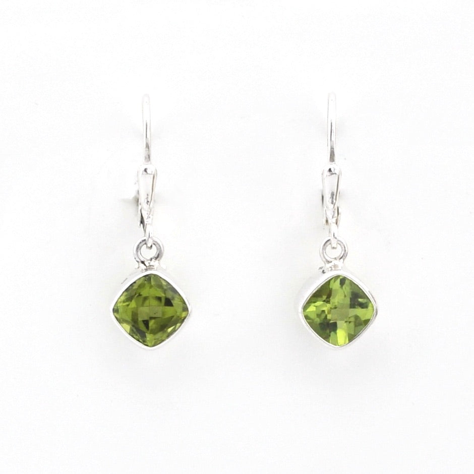 Green gemstone earrings on white background