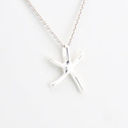 Silver starfish pendant necklace on a white background