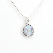 Silver necklace with round Roman glass on white background
