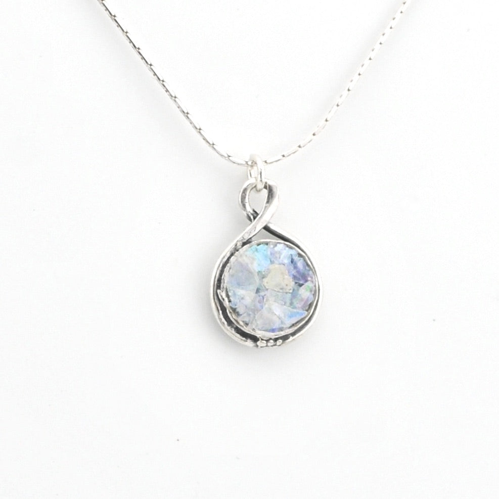 Silver necklace with round Roman glass on white background