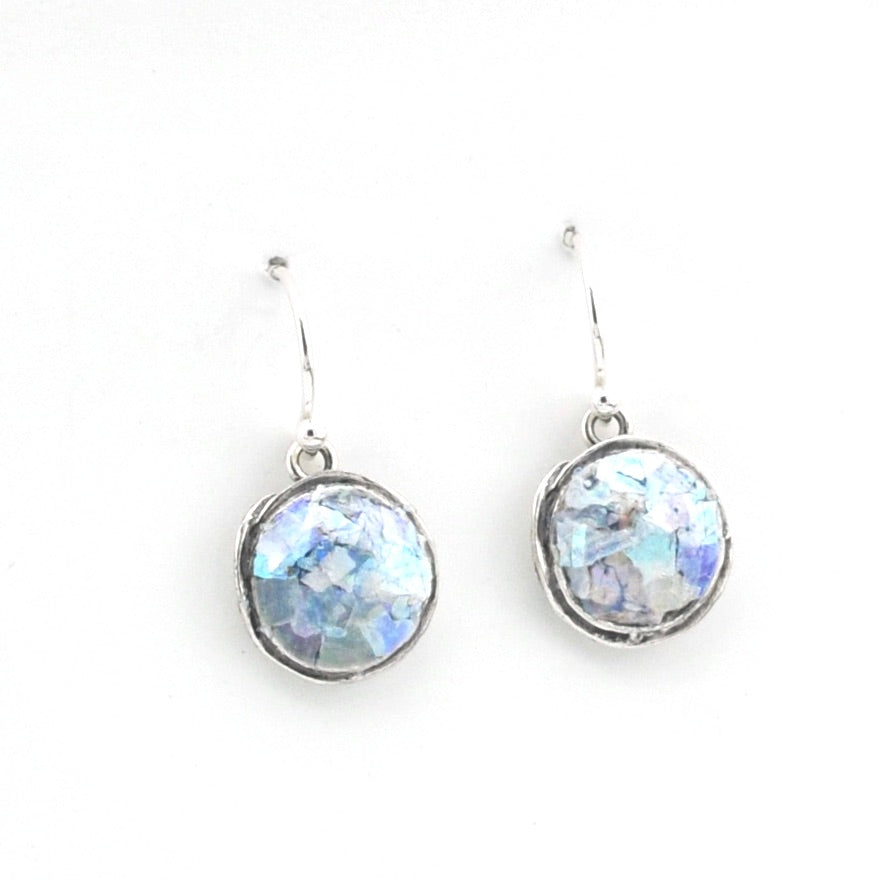 Pair of silver earrings with round, faceted gemstones on a white background