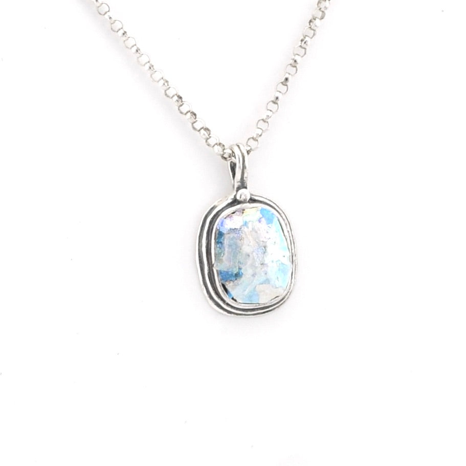 Silver necklace with a pendant featuring a blue Roman glass on a white background