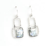 Pair of silver earrings with rectangular stone on a white background