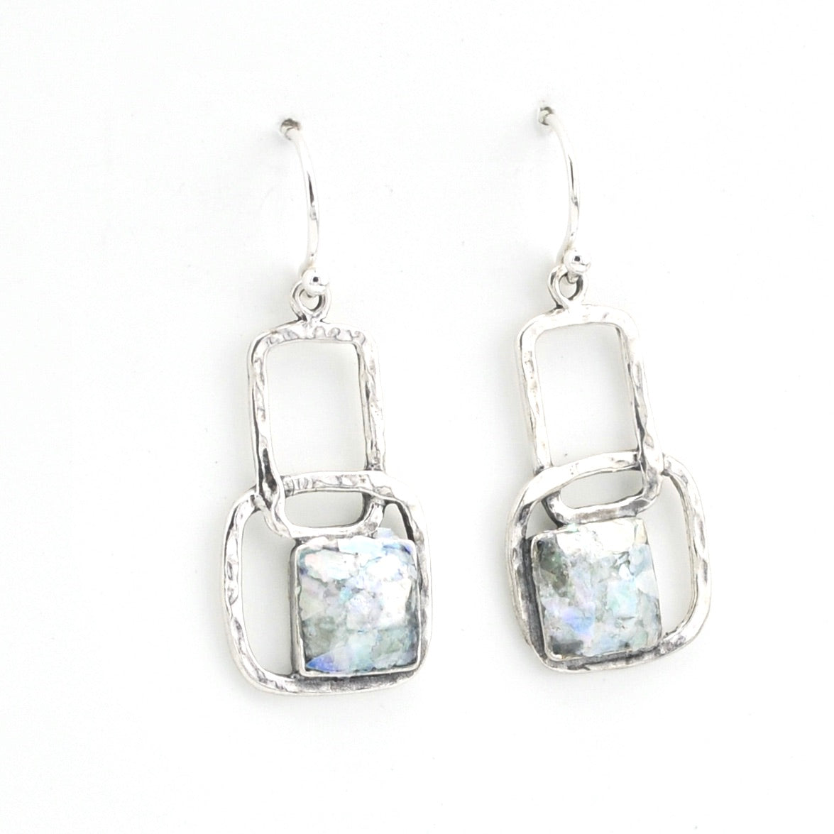Pair of silver earrings with rectangular stone on a white background