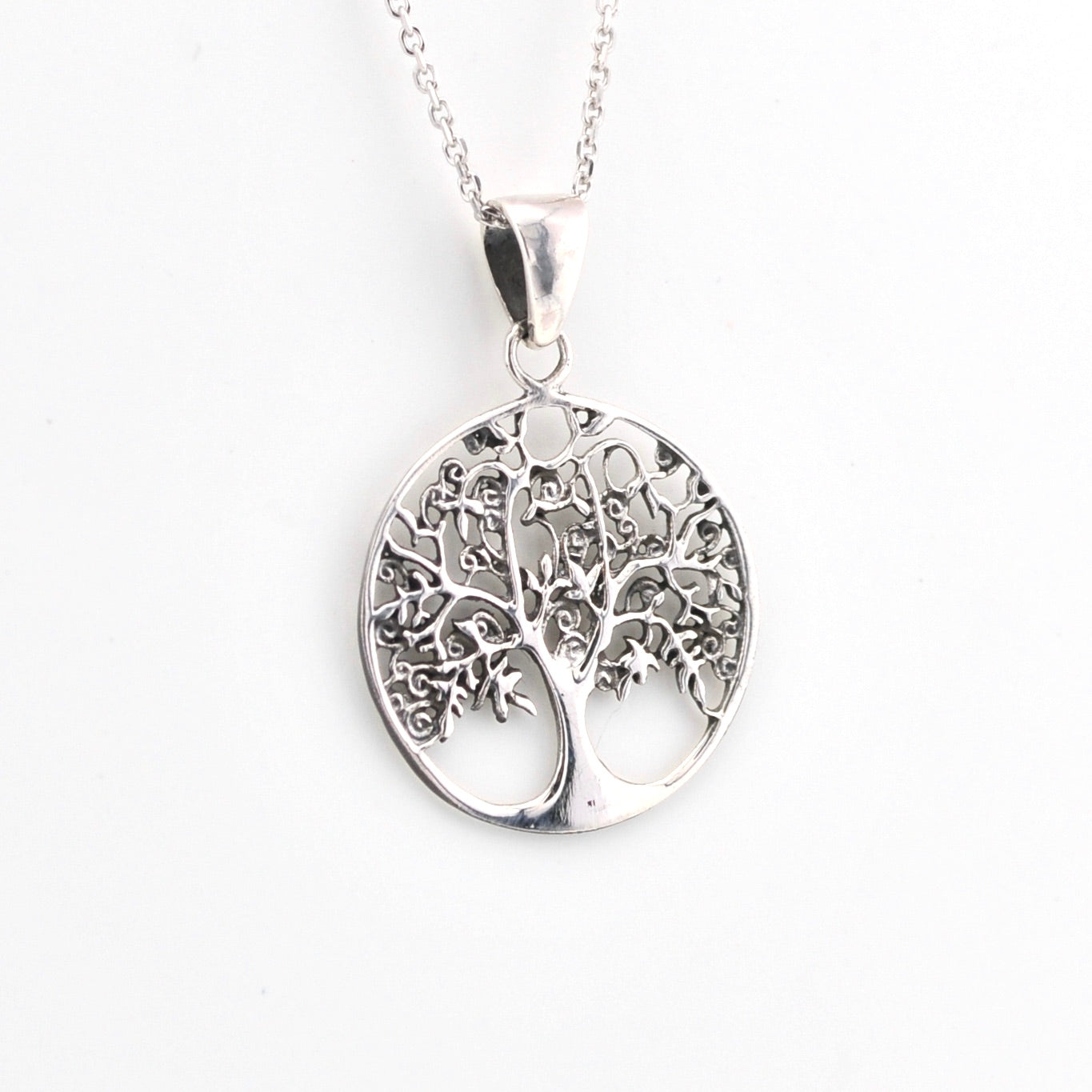 Silver tree of life pendant on a white background
