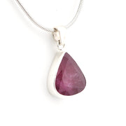 Teardrop-shaped pink gemstone pendant on a silver chain against a white background