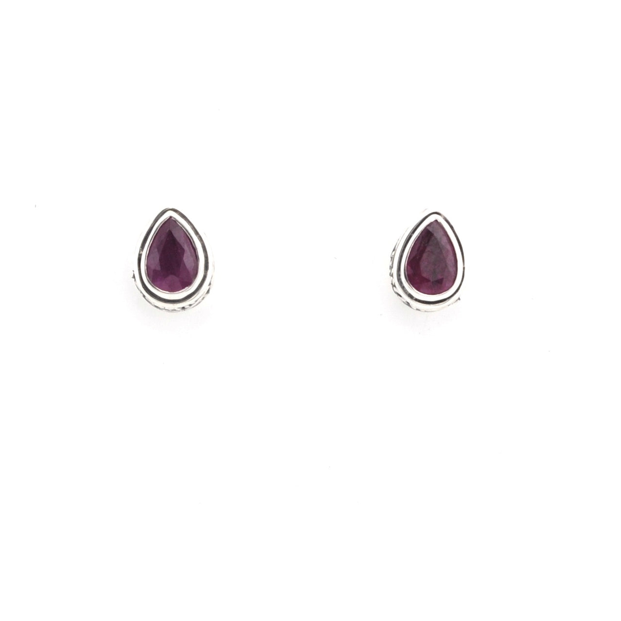 Pair of gold earrings with ruby gemstones on a white background