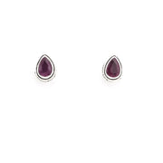Pair of gold earrings with ruby gemstones on a white background