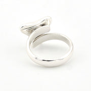 Silver ring with a unique design on a white background