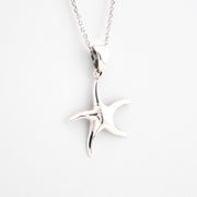 Silver starfish pendant on a chain against a white background