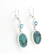 Pair of earrings with turquoise stones and blue gemstones on a white background
