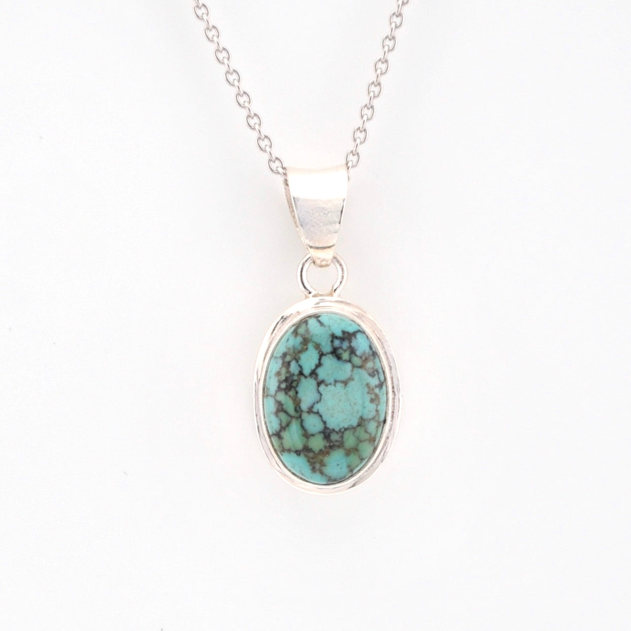 Turquoise pendant necklace on a white background