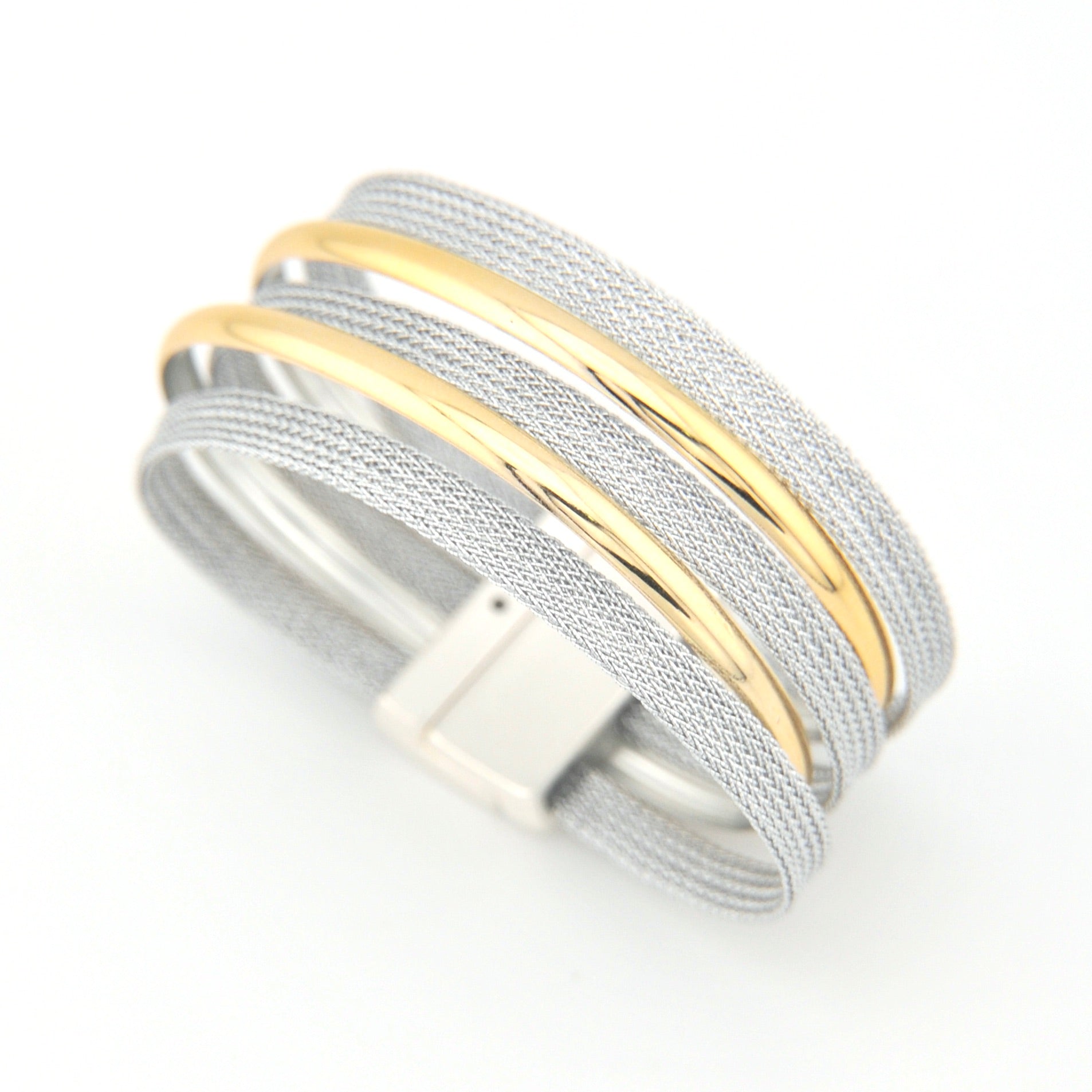 Stack of silver and gold bracelets on a white background