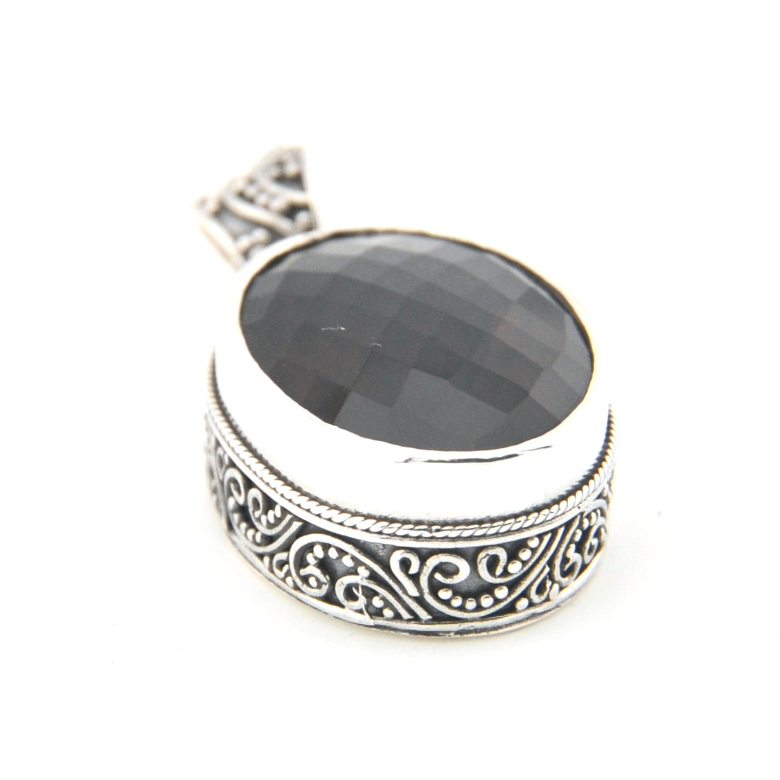 Silver pendant with brown stone on a white background