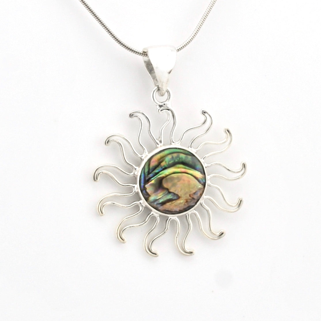 Silver sun-shaped pendant with a colorful center on a white background