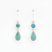 Pair of earrings with turquoise stones on a white background