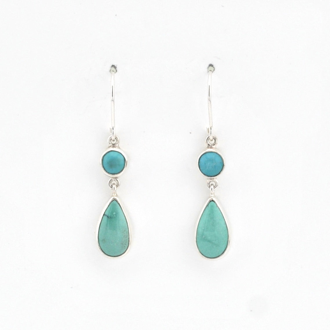 Pair of earrings with turquoise stones on a white background