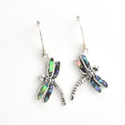 A pair of silver dragonfly drop earrings with iridescent abalone shell wings, displayed on a clean white background.