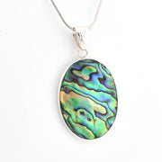 Oval abalone shell pendant on a silver chain against a white background